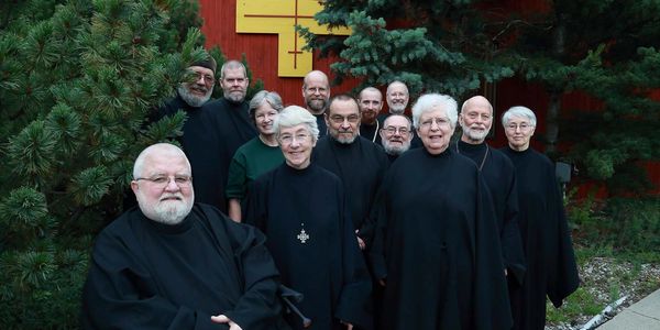 The monks and nuns of New Skete posing for a group photo outside of Holy Wisdom Church
