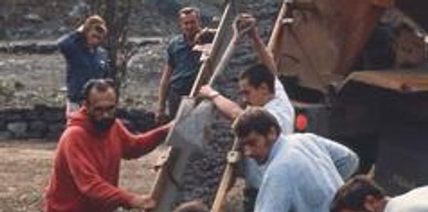 Monks pouring concrete