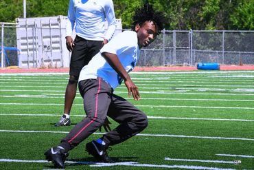 Athlete practicing agility drills on a sports field.