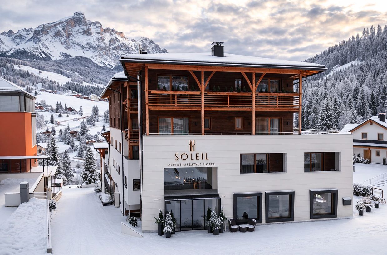 Soleil Alpine Lifestyle Hotel nestled in snowy mountains with wooden and white exterior.
