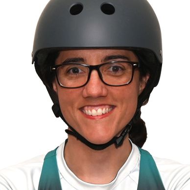 Smiling person wearing glasses and a black helmet.