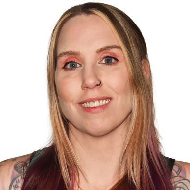 Smiling woman with blonde and purple hair, nose ring, and tattoos.