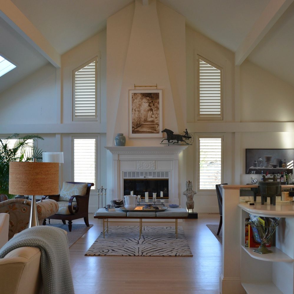 Elegant living room with white fireplace and modern decor.
