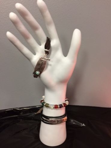White hand mannequin with bracelets and keychain.