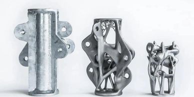 Three metal components showing progressive lightweight design.