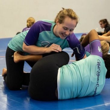 A room of combat athletes drilling moves.