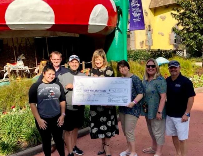 Give Kids the World check presentation from Indy Disney Meet fundraiser. 