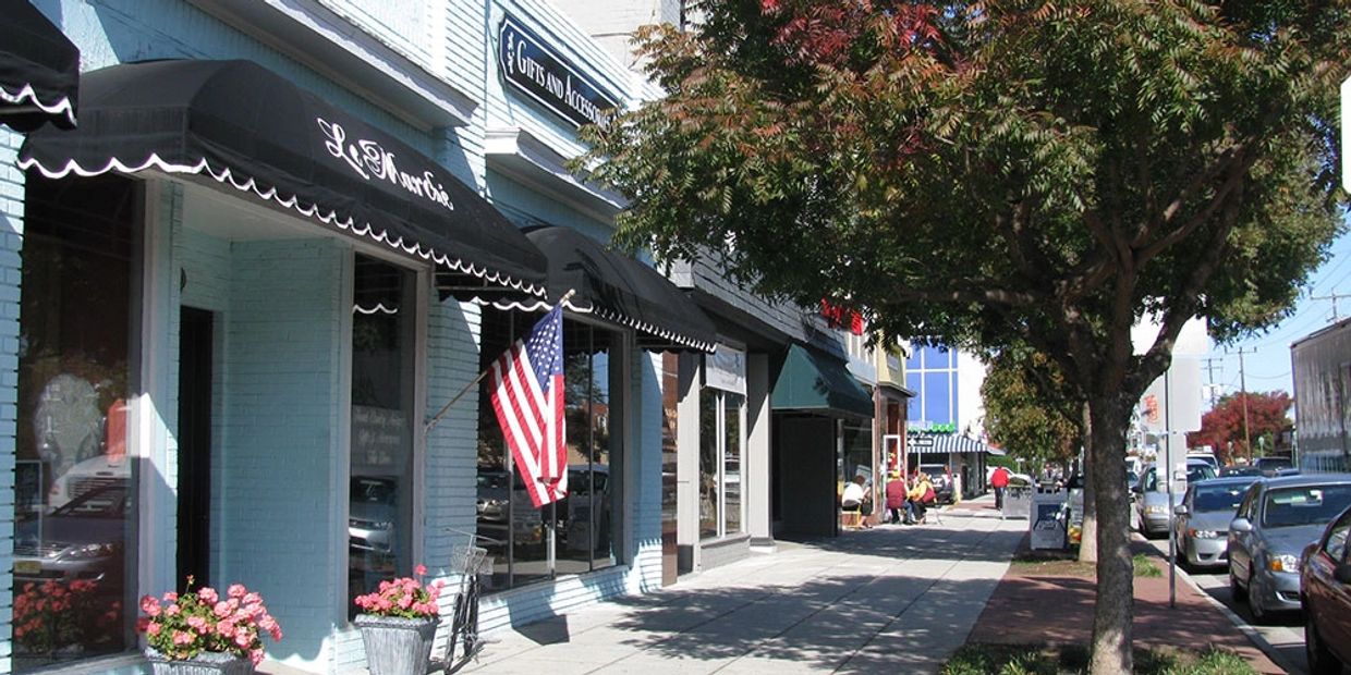 American flag with buildings and sidewalk. Veterans Moving can do commercial moves as well. 