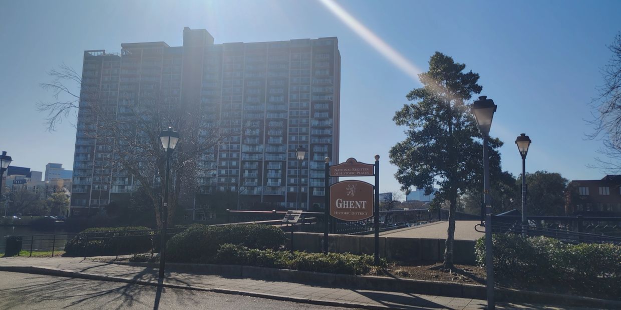 Ghent Historic District National Register sign with Hague Towers high-rise apartments in background 