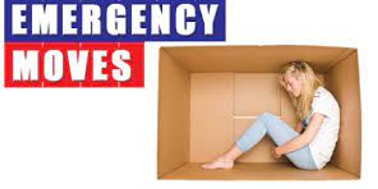 Distressed woman sitting inside a cardboard box.