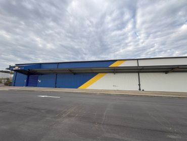 Empty loading dock area with a large warehouse wall.