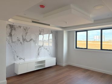 Modern empty room with wood floor and marble wall.