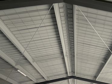Steel roof structure over industrial area.