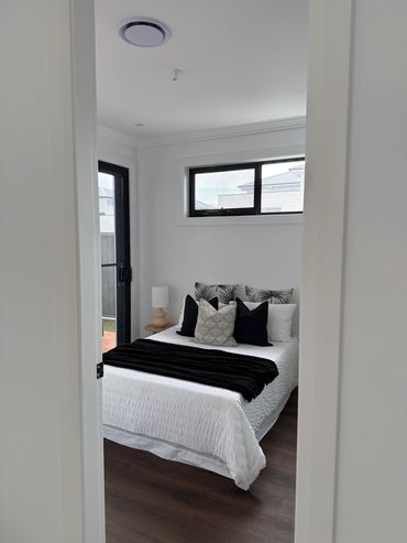 Minimalist bedroom with white and black decor.