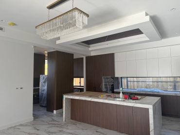Modern kitchen with marble floor and island.