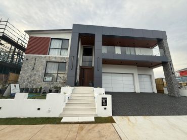 Modern two-story house with stairs and garage.
