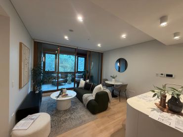 Cozy modern living room with gray sofa and round table.