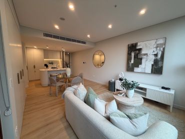 Modern open-plan living room with neutral tones.