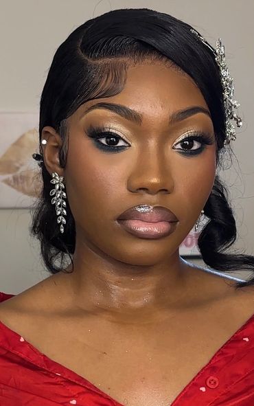 Close-up of a woman with elegant makeup and jewelry.
