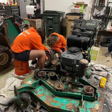 Working on a walk behind mower