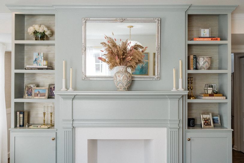 Elegant mantel with decorative vase and mirror.