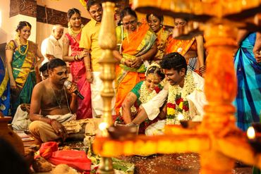 Traditional Indian wedding ceremony with couple and priest.
