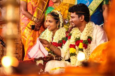 Candid Tamil bride and groom during wedding ritual in Karaikudi by Luster Pearl Media.