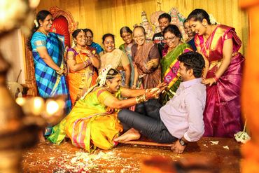 A joyful Indian wedding ritual with bride playfully interacting with groom.