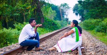 Couple on train tracks for pre-wedding shoot in Thanjavur & Karaikudi by Luster Pearl Media.