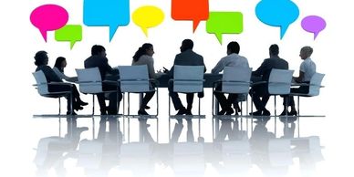 Business meeting with colorful speech bubbles showing discussion.