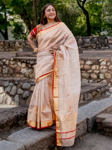 Hand weaved chanderi saree, with thick golden border, buti all over and hints of red
