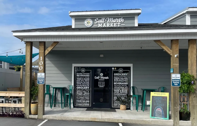 Salt Marsh Market Storefront with shark bite slushie chalkboard. 
