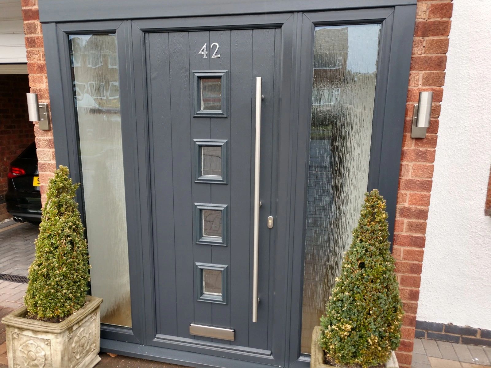 Anthracite Grey Solid Core front door with two full height side panels and a Long bar handle.