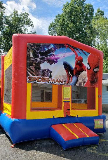 Colorful Spider-Man inflatable bounce house outdoors.