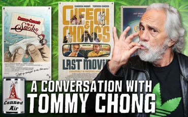 Tommy Chong poses for a conversation event with cannabis-themed movie posters.