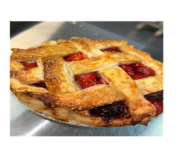 Close-up of a freshly baked lattice-top berry pie.