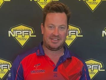 Man wearing a red and blue Falcons sports jersey in front of an NPFL backdrop.