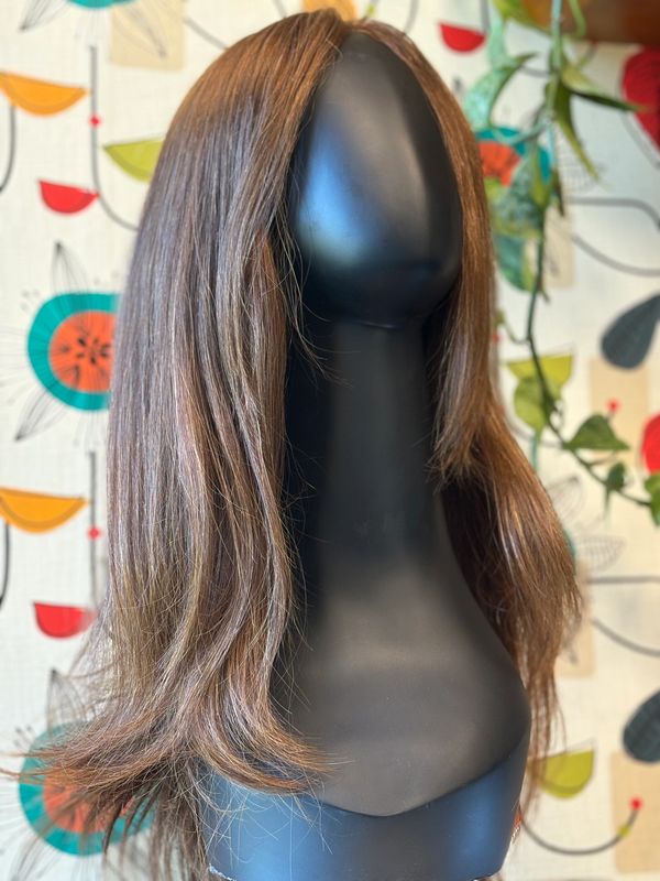 A long brown wig on a mannequin head