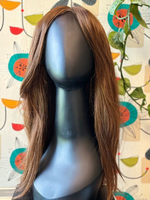 A long brown wig on a mannequin head