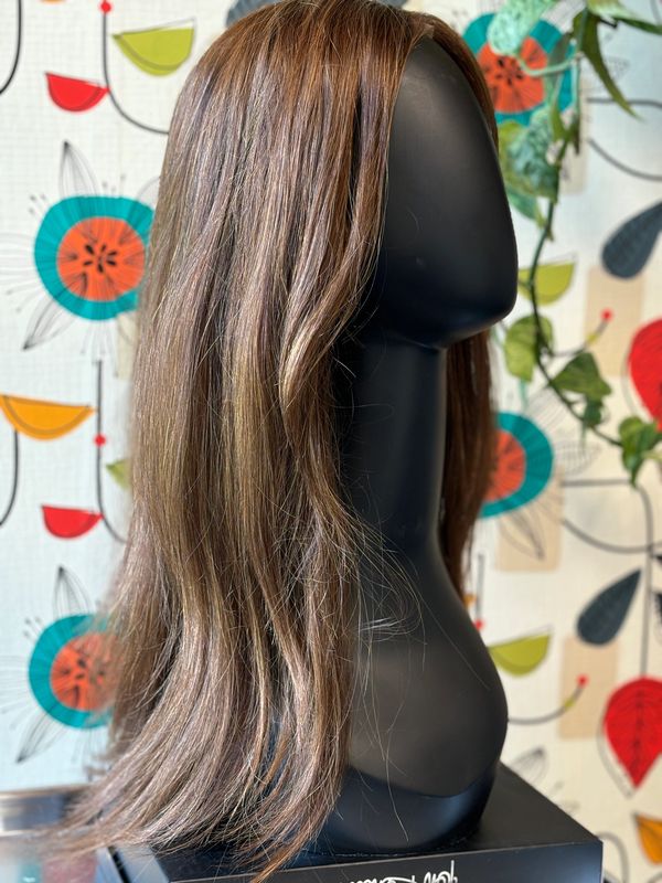 A long brown wig on a mannequin head