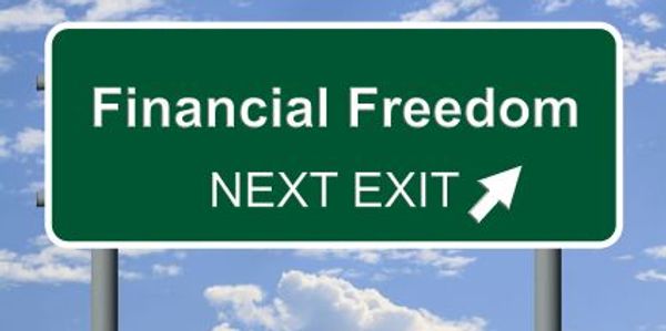 Highway sign indicating 'Financial Freedom' at the next exit.