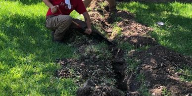 plumbers digging a water line tunnel in the ground 