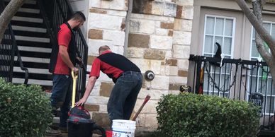 plumbers working on converse apartment leak