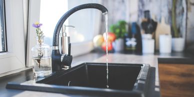 A sink with the water running 