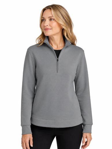 Woman wearing a gray quarter-zip pullover with black pants.