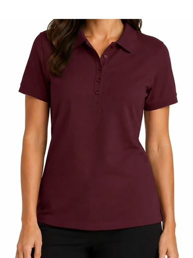 Woman wearing a maroon polo shirt and black pants, smiling at the camera.