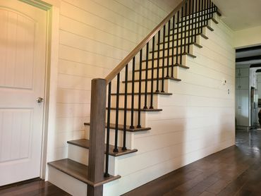 Replaced existing staircase . metal spindles. maple railing and treads, shiplap wall