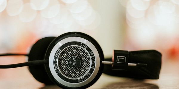Radio on-air personality's headphones on desk. 