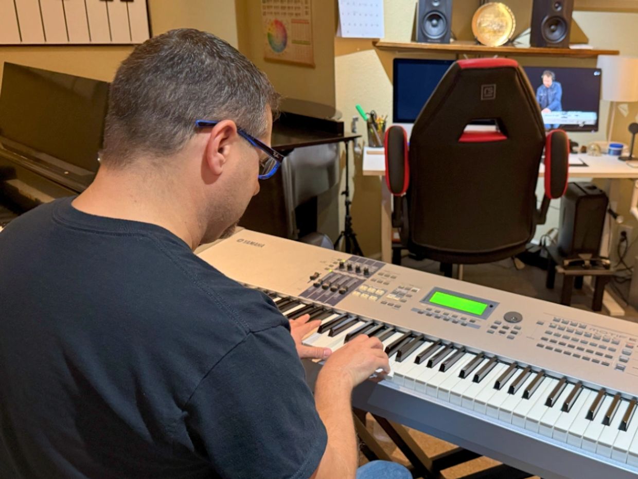 Chris Hanson playing on his keyboard preparing for a piano music lesson in Las Vegas.
