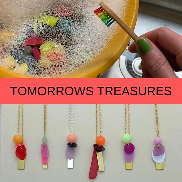 a soapy bucket of plastic waste and a toothbrush alongside beautiful simple colourful necklaces made
